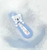 A blue baby bath thermometer shaped like a koala, floating in soapy water. Náhled obrázku produktu
