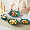 A person is eating a meal at a table with several plates of food and dishes. Produktbild-Vorschau