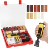 A hand holds a yellow and black repair tool over a red case containing various colored repair sticks and batteries. Náhled obrázku produktu