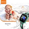 A young girl is playing in the water with a smartwatch on her wrist, and a smartwatch is shown in the foreground. Náhled obrázku produktu