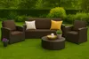 An outdoor furniture set on a green lawn with a hedge in the background. Anteprima dell’immagine prodotto