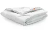 A white comforter is folded and placed on a white background. Produktbild-Vorschau