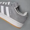 A close-up view of the side of a gray Adidas Campus sneaker. Voir les images du produit
