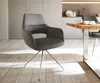 A modern dining room with a grey armchair and a wooden table. Produktbild-Vorschau