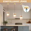 A modern kitchen with three pendant lights hanging over a counter. Anteprima dell’immagine prodotto