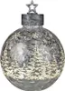 A silver Christmas ornament with a winter forest scene and snowflakes. Produktbild-Vorschau