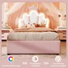 A pink children's bed with a crown-shaped headboard and LED lighting, set in a bedroom with pink drapes and fairy lights. Produktbild-Vorschau