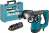 A Makita HR2811FT Kombihammer is displayed with its case and an accessory. Podgląd zdjęcia produktu