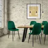 A dining room scene with a wooden table and green velvet chairs. Náhľad obrázku produktu