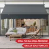 An outdoor patio with a sofa, coffee table, and chair under a dark gray awning. Produktbild-Vorschau