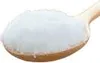 A close-up shot of a wooden spoon filled with white powder, likely creatine supplement. Produktbild-Vorschau