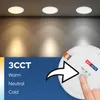A close-up of a hand adjusting a switch on a white LED light fixture, with three lights on a ceiling in the background showing different color temperatures. Anteprima dell’immagine prodotto