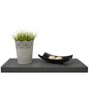 A gray floating shelf with a potted plant and a decorative bowl with two candles. Náhled obrázku produktu