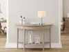 A console table with decorative items and a lamp in a room. Náhled obrázku produktu