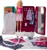 A Barbie doll is shown with a sewing kit and various fabric pieces, dress templates, and accessories. Produktbild-Vorschau