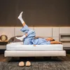 A person is lying on a mattress in a bedroom setting. Produktbild-Vorschau