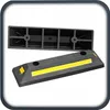 Two black parking stops with yellow reflective strips, one is a long rectangular block, the other is a wedge-shaped block. Produktbild-Vorschau