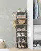 A narrow, tall shoe rack with multiple shelves stands next to a closet. Náhled obrázku produktu