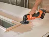 A person is using a power tool to sand a door. Produktbild-Vorschau