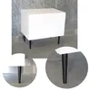 A white cabinet with black legs is shown against a textured gray wall and concrete floor. Produktbild-Vorschau