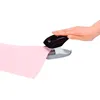 A hand is pressing down on a black and gray stapler, which is punching a hole in a piece of pink paper. Anteprima dell’immagine prodotto