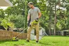 A man is using a cordless trimmer in a garden. Produktbild-Vorschau