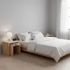 A bedroom scene with a bed, nightstands, and a lamp. Produktbild-Vorschau