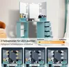 A turquoise vanity table with a tri-fold mirror and LED lights, showcasing different lighting options. Voir les images du produit