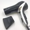 A black and silver Braun Satin Hair 7 hairdryer with its concentrator nozzle detached, placed on a white background. Produktbild-Vorschau