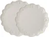 Two white scalloped plates with embossed designs are shown. Produktbild-Vorschau