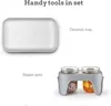 A white ceramic tray and a gray steam pot holder with two glass jars are shown against a white background. Produktbild-Vorschau