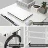 A collage of images showing different aspects of a white standing desk, including its tabletop, a laptop, mouse, books, a plant, headphones, and a metal frame. Podgląd zdjęcia produktu