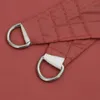 A close-up view of the corner of a terracotta-red sail shade, showing the reinforced corner with a metal D-ring and white webbing. Náhľad obrázku produktu