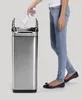 A person is shown discarding a plastic bottle into a stainless steel trash can. Voir les images du produit