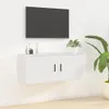 A white TV cabinet mounted on a white wall, with a TV mounted above it. Voir les images du produit