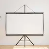 A white projection screen with a black frame and tripod stand is shown against a white wall and wooden floor. Podgląd zdjęcia produktu