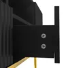 A close-up view of a black cabinet drawer with visible screws and a gold leg. Produktbild-Vorschau