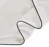 A close-up of white fabric with a black trim, likely a bedding product. Produktbild-Vorschau