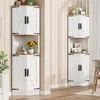 Two white corner cabinets with wood-toned tops and black hardware are shown in a room with light-colored walls and wooden flooring. Podgląd zdjęcia produktu