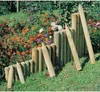 A garden scene with wooden border posts and colorful flowers. Produktbild-Vorschau