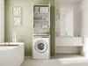 A modern bathroom with a washing machine cabinet, bathtub, and vanity. Produktbild-Vorschau