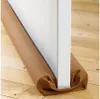 A brown draft stopper is placed along the bottom of a white door on a wooden floor. Anteprima dell’immagine prodotto
