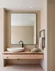 A modern bathroom vanity with a sink, faucet, and mirror. Produktbild-Vorschau