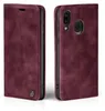A burgundy flip case for a smartphone, shown from the front and back. Produktbild-Vorschau
