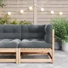 An outdoor patio setting with a wooden sofa and string lights. Anteprima dell’immagine prodotto