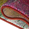 A close-up view of a folded rug, showing the texture and edge binding. Podgląd zdjęcia produktu