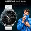 A man in a blue jacket is laughing in the rain next to a smartwatch that is getting wet. Produktbild-Vorschau