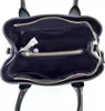 The inside of an open black handbag. Produktbild-Vorschau