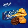 A product shot of Delicje orange biscuits on a blue background with oranges and chocolate. Anteprima dell’immagine prodotto