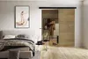 A bedroom scene featuring a sliding door, bed, and artwork. Náhled obrázku produktu